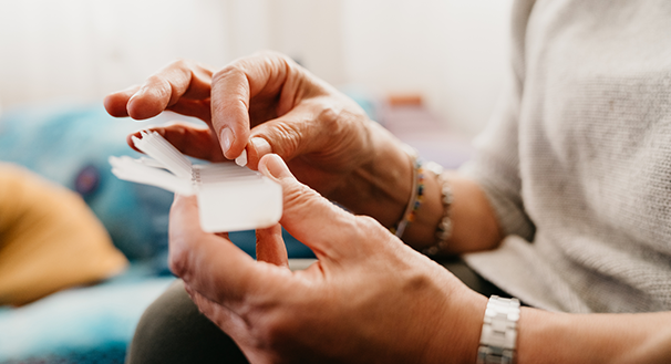 a hand holding a remote control