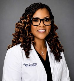 Chavona Moore, FNP-C, nurse practitioner in a white coat, smiling.