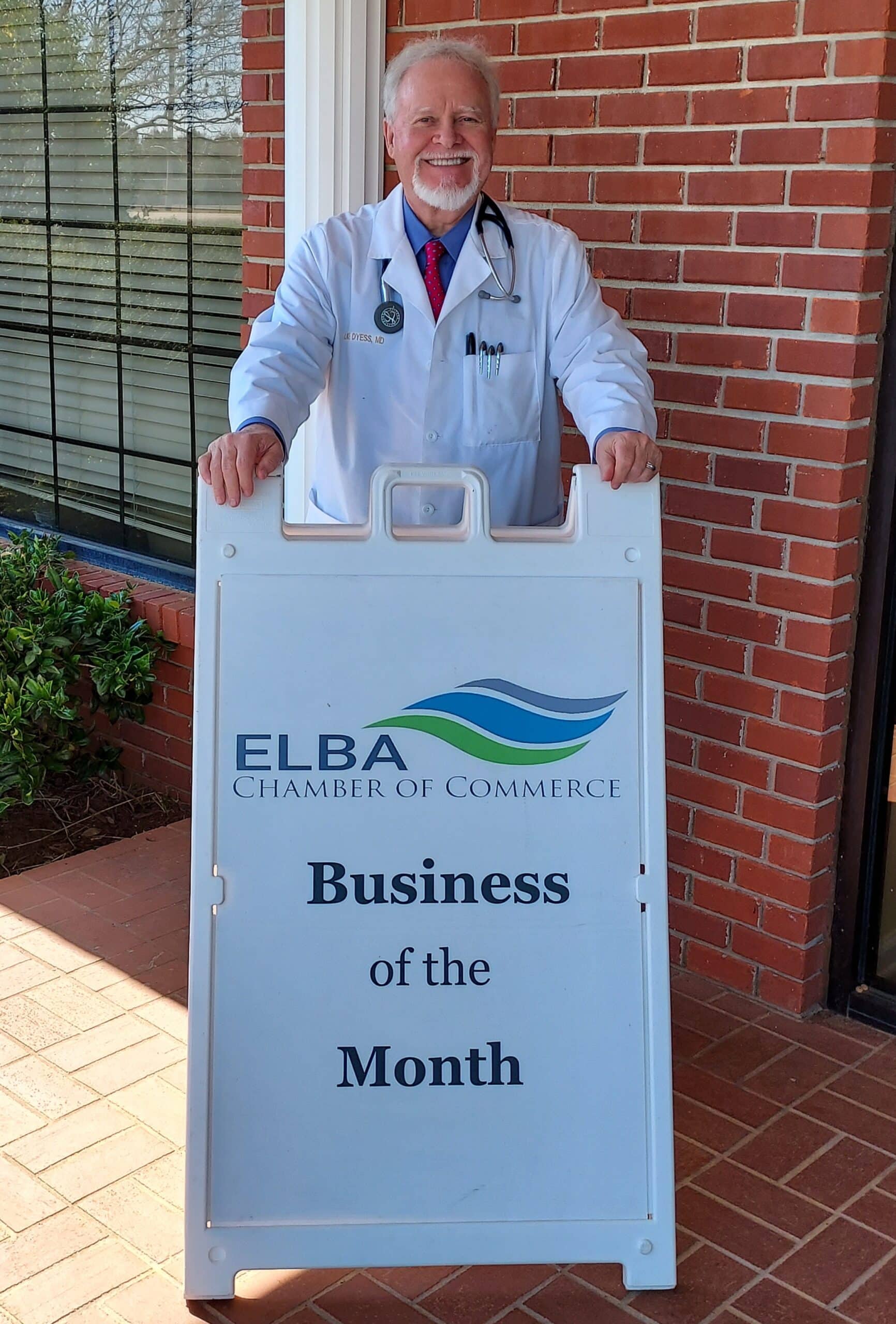 a man standing in front of a sign