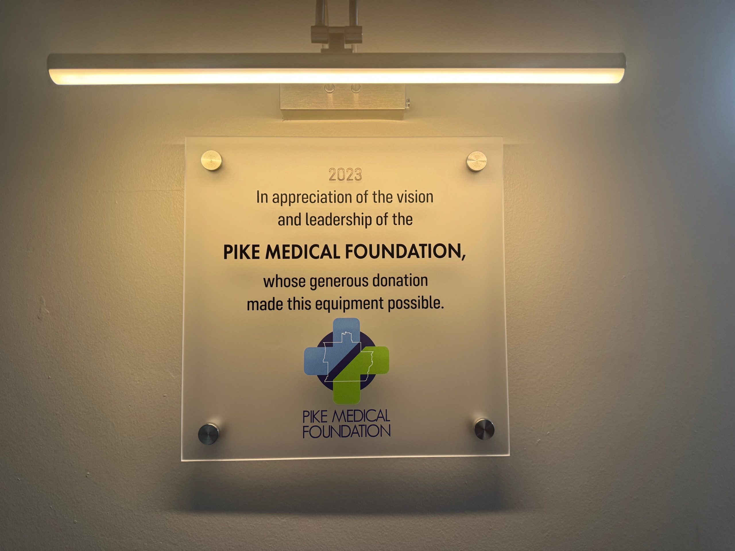 Plaque recognizing Pike Medical Foundation's donation under bright light.