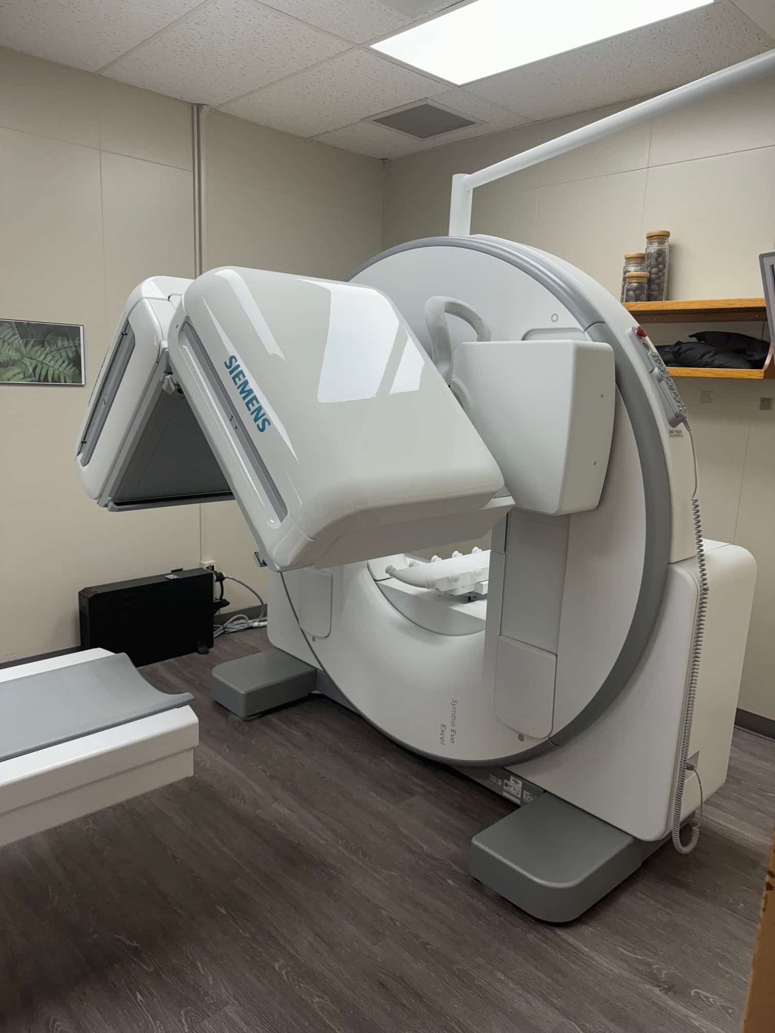 Medical imaging equipment in a hospital examination room.