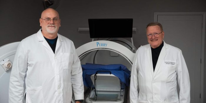 a man standing in front of a group of people posing for the camera
