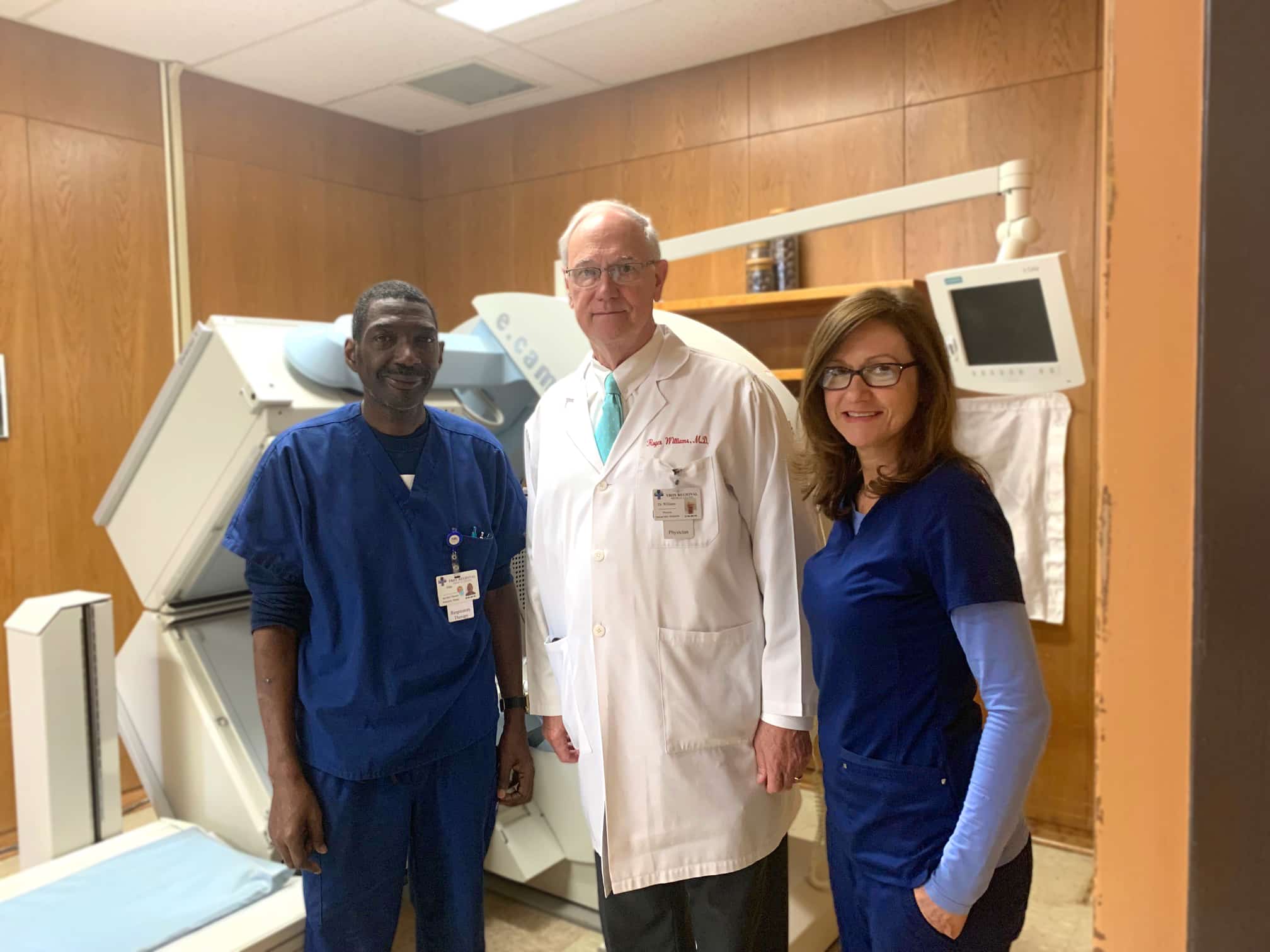 a person standing in front of a group of people posing for the camera