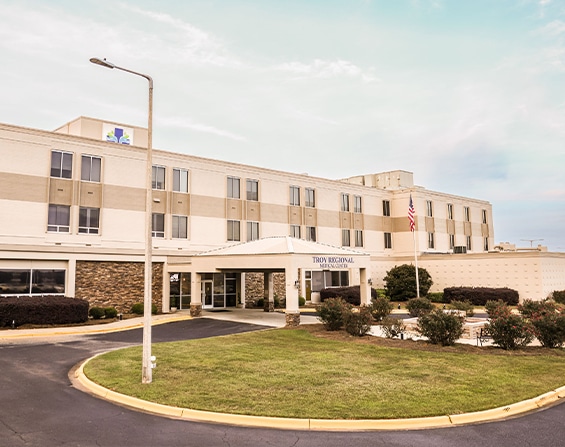 Front view of Troy Regional Medical Center building under a clear sky.