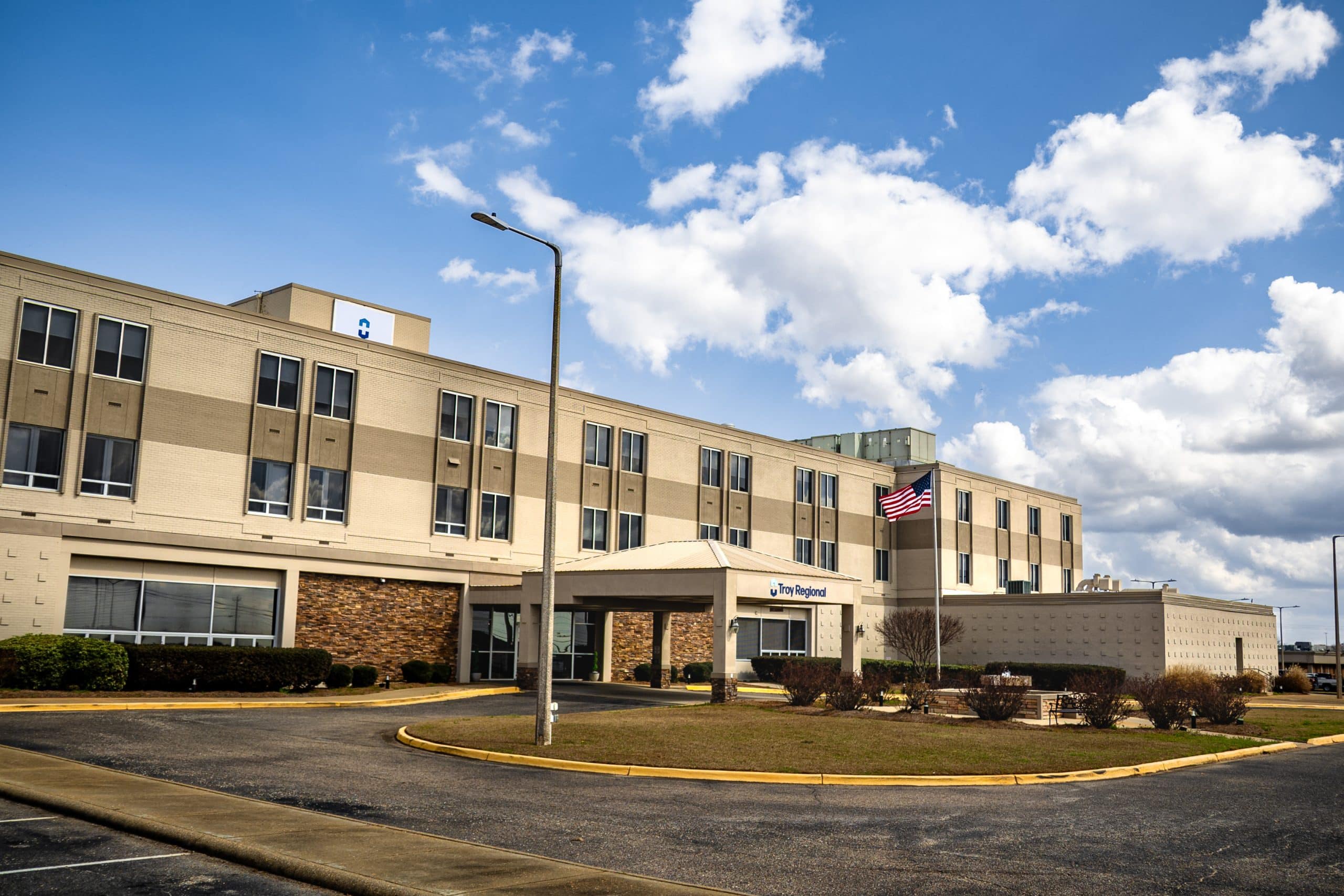 Troy Regional Medical Center building with an American flag.